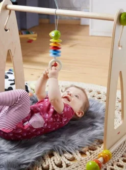 HABA Dangling Figure Parrot Stroller & Crib Toy< Play Gyms, Play Mats + Accessories