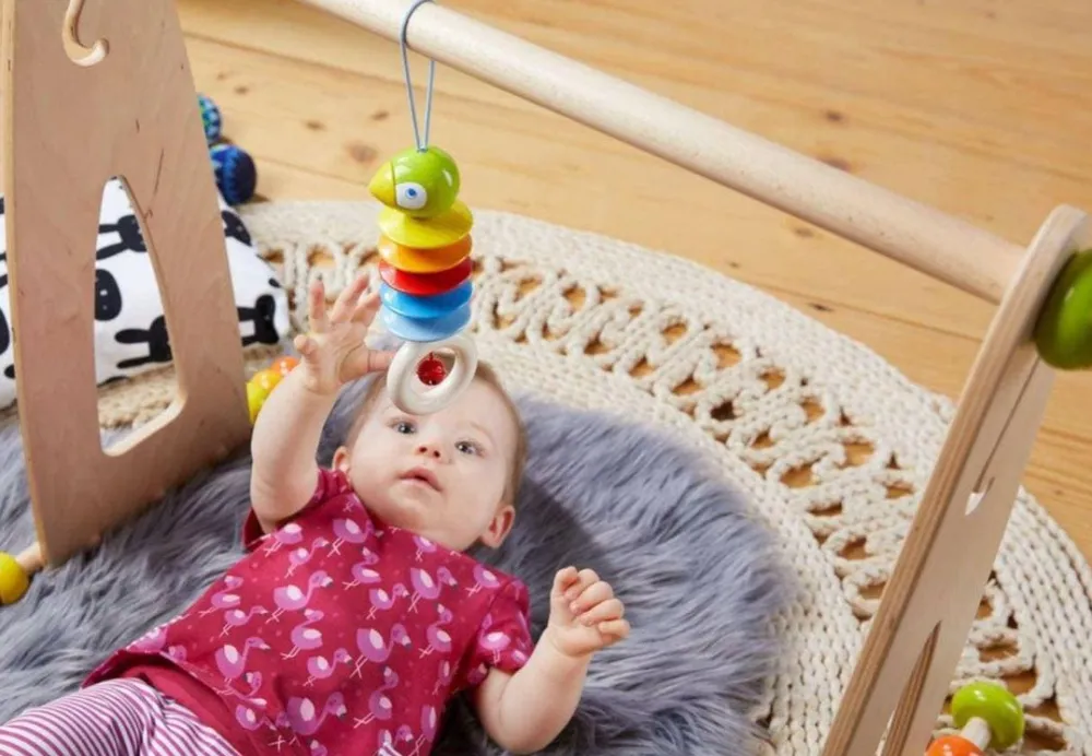 HABA Dangling Figure Parrot Stroller & Crib Toy< Play Gyms, Play Mats + Accessories